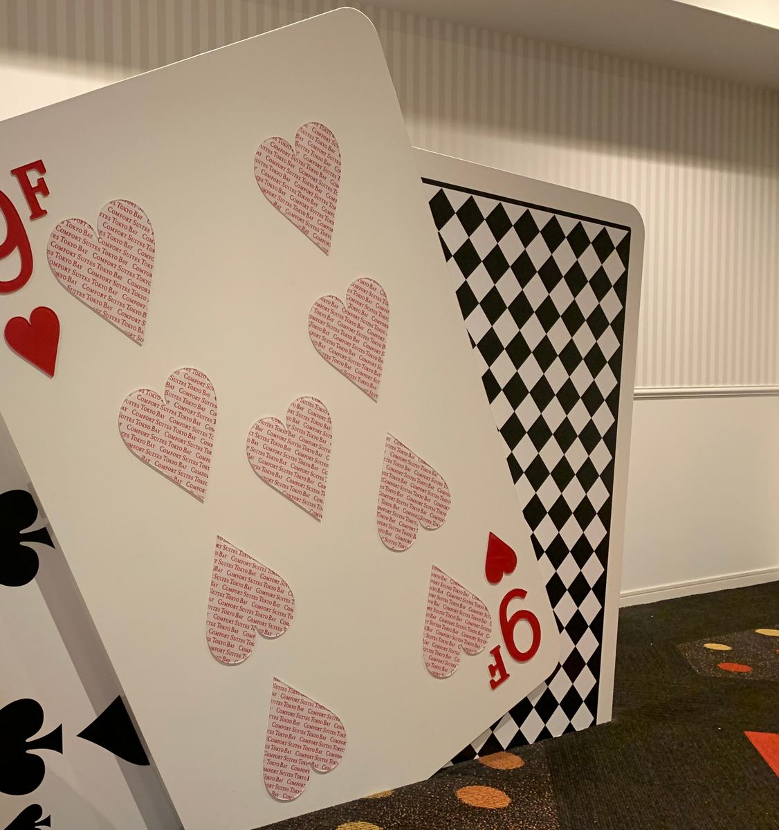 Giant playing-card decorations in a hotel corridor