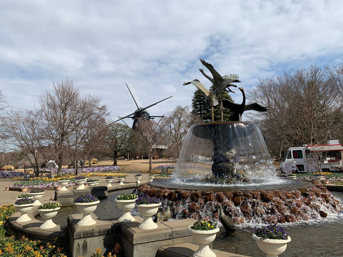 The fountain monument near the park entrance, with the Danish-style windmill behind it