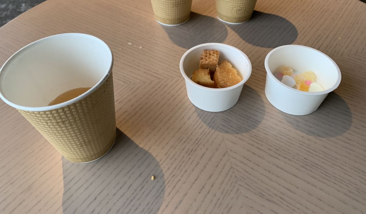 Lounge snacks at Grand Mercure Nasu Highlands — paper cups of tea and juice beside small cups of sweets and rice crackers on a table