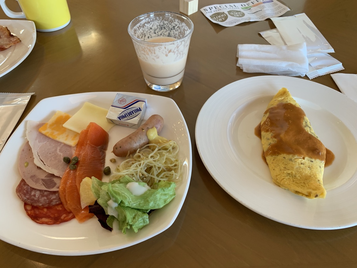 Breakfast plate with omelet, smoked salmon, ham, and cheese from the hotel buffet