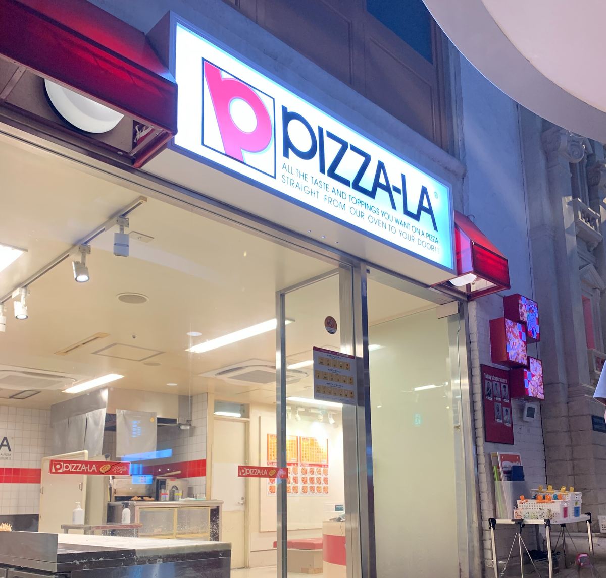 The PIZZA-LA storefront inside KidZania Tokyo, a kid-sized replica of the real Japanese pizza chain