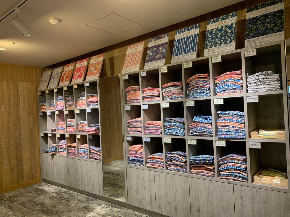 Shelves of colorful yukata robes in many sizes, including kids' sizes, for guests to choose from