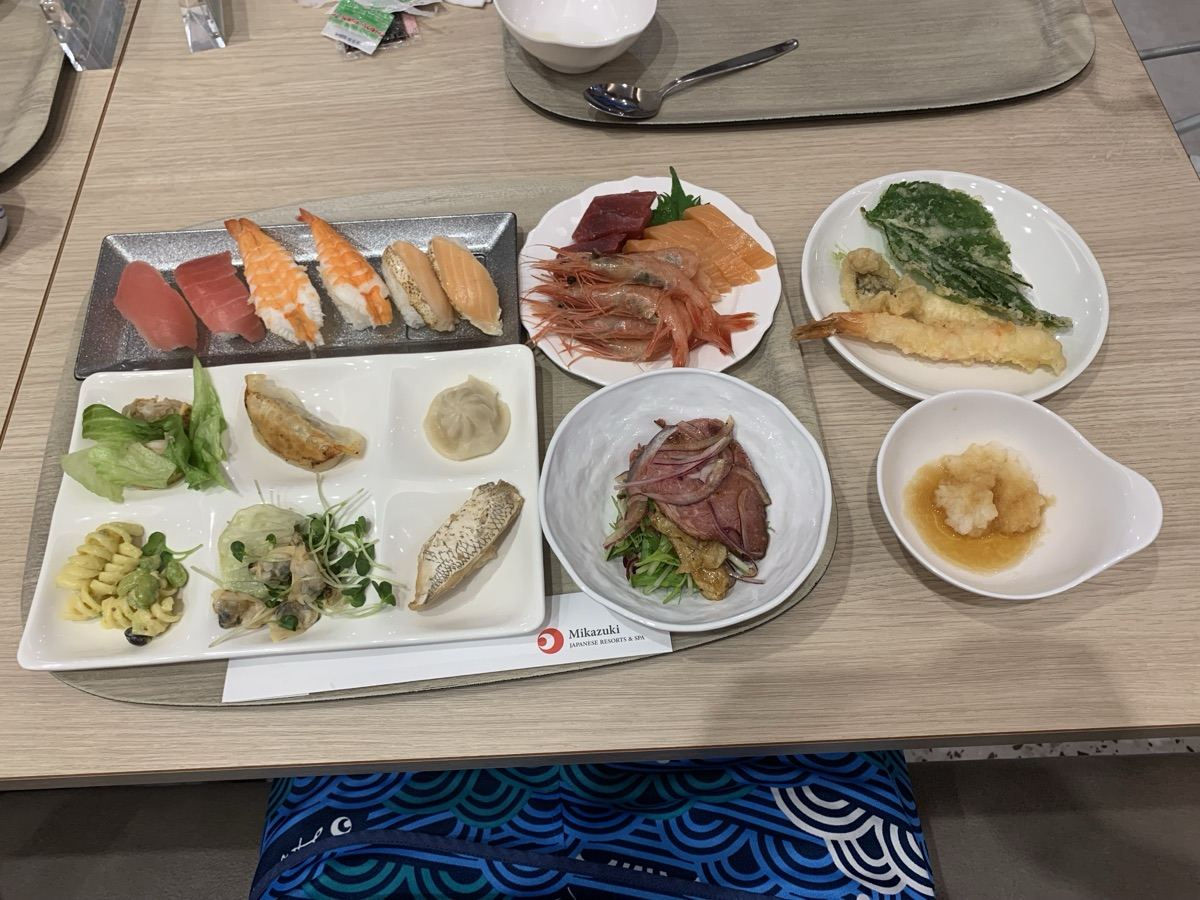 A dinner buffet tray with sushi, sashimi, tempura, and small dishes at Hotel Mikazuki