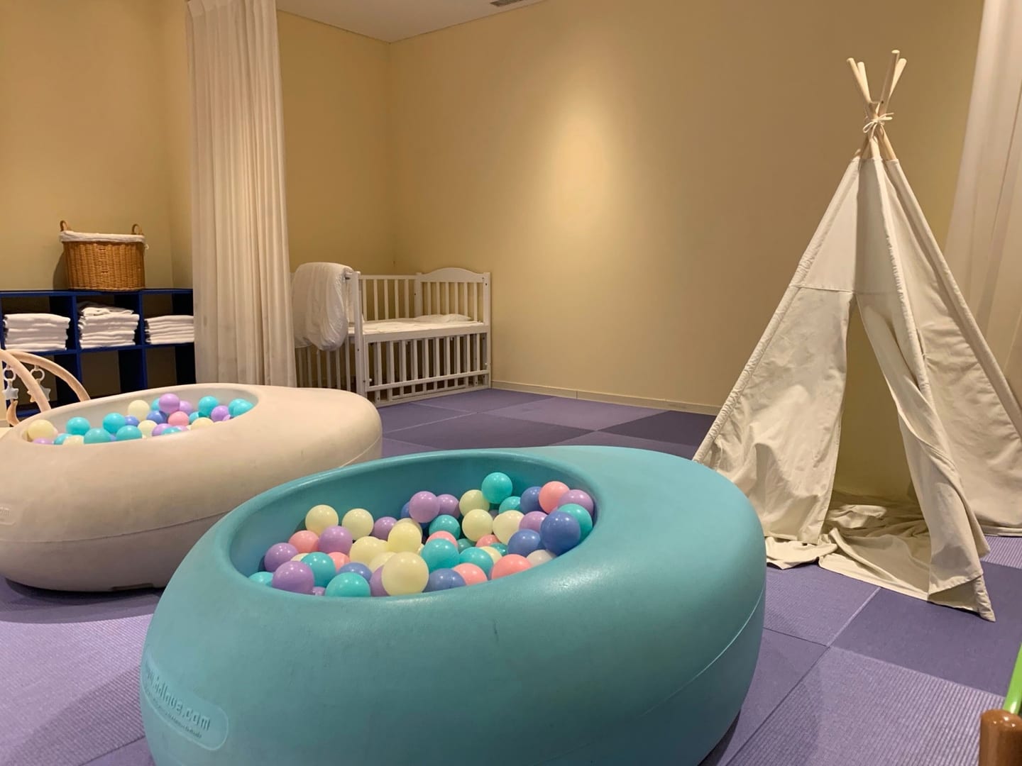 Ball pools, a play tent and a cot in the nursery