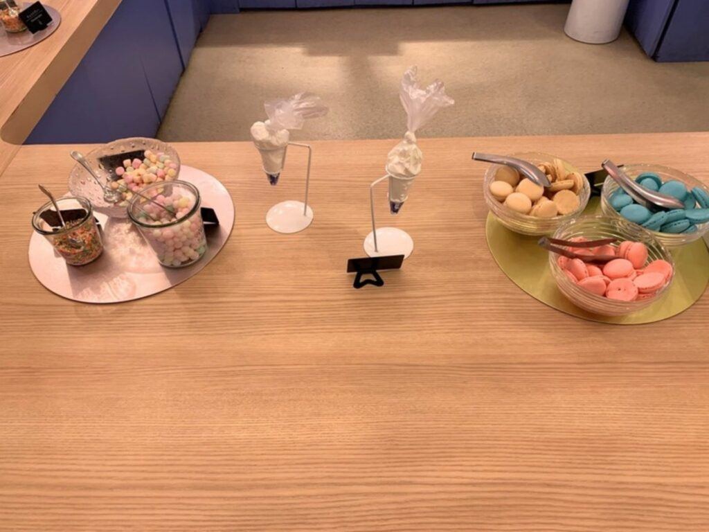A table of macaron toppings for the Kids Pâtissier activity