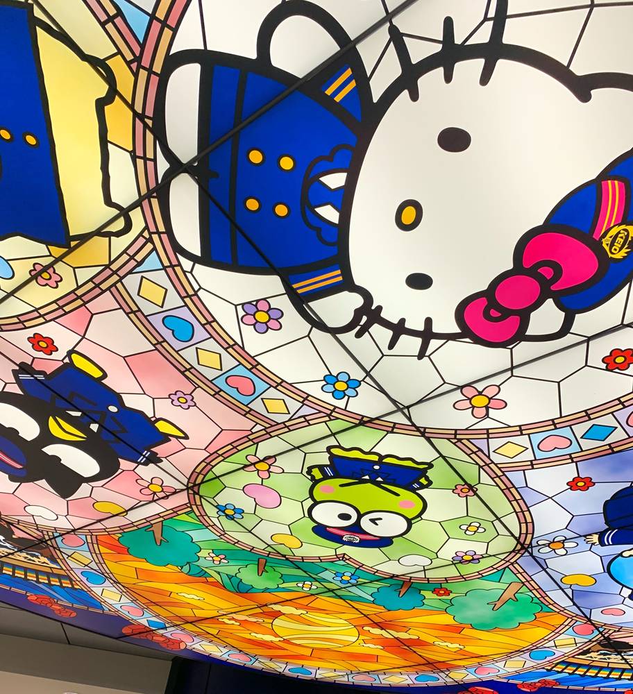 A stained-glass style ceiling featuring Hello Kitty and Sanrio characters