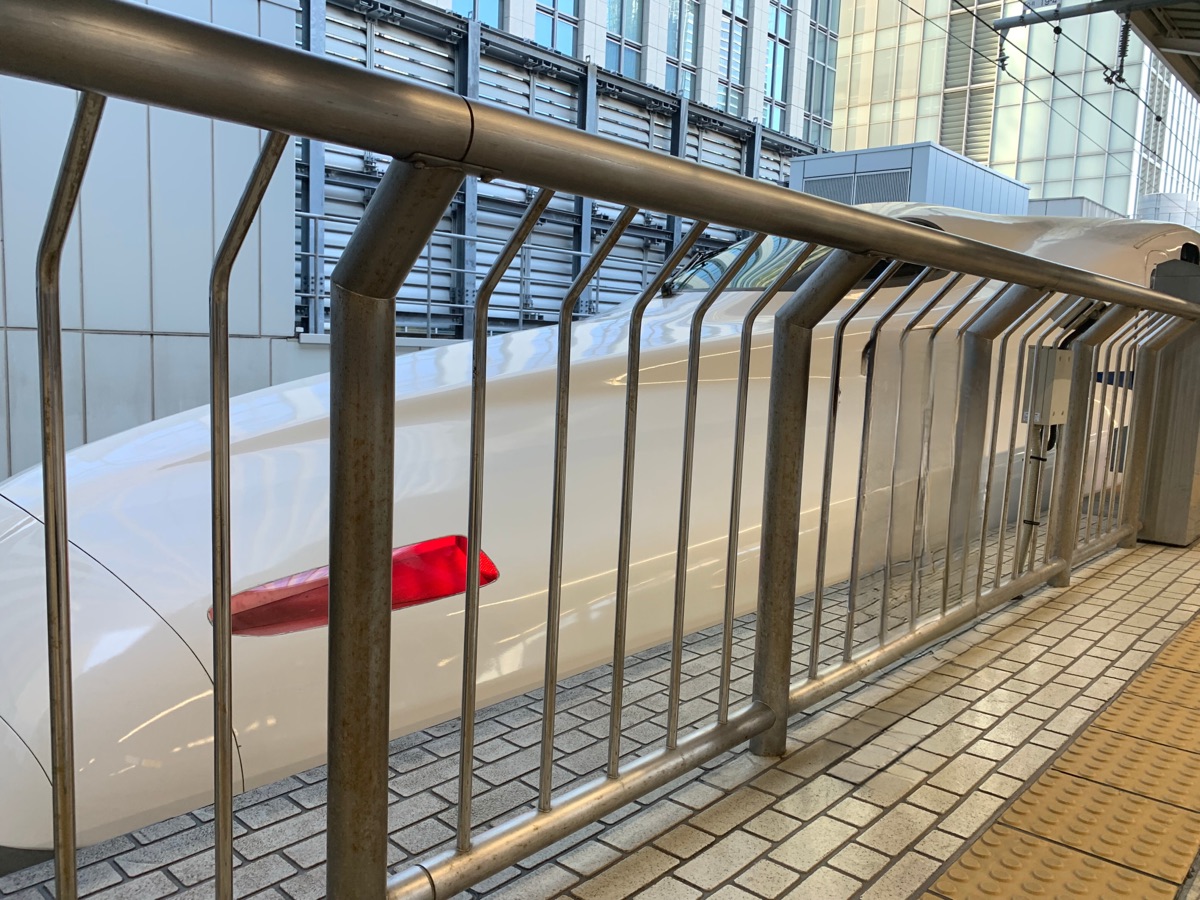 Close-up of a Shinkansen train's nose at the platform