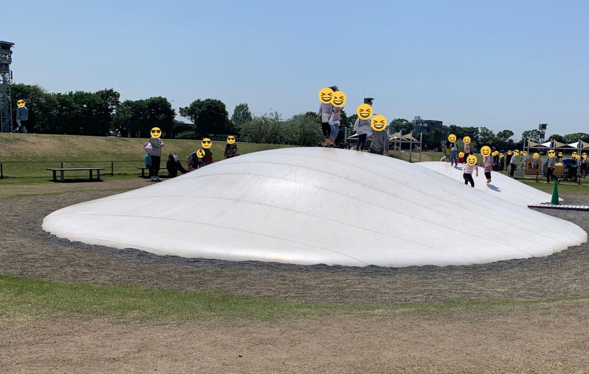 The white inflatable bouncy dome with children jumping on it